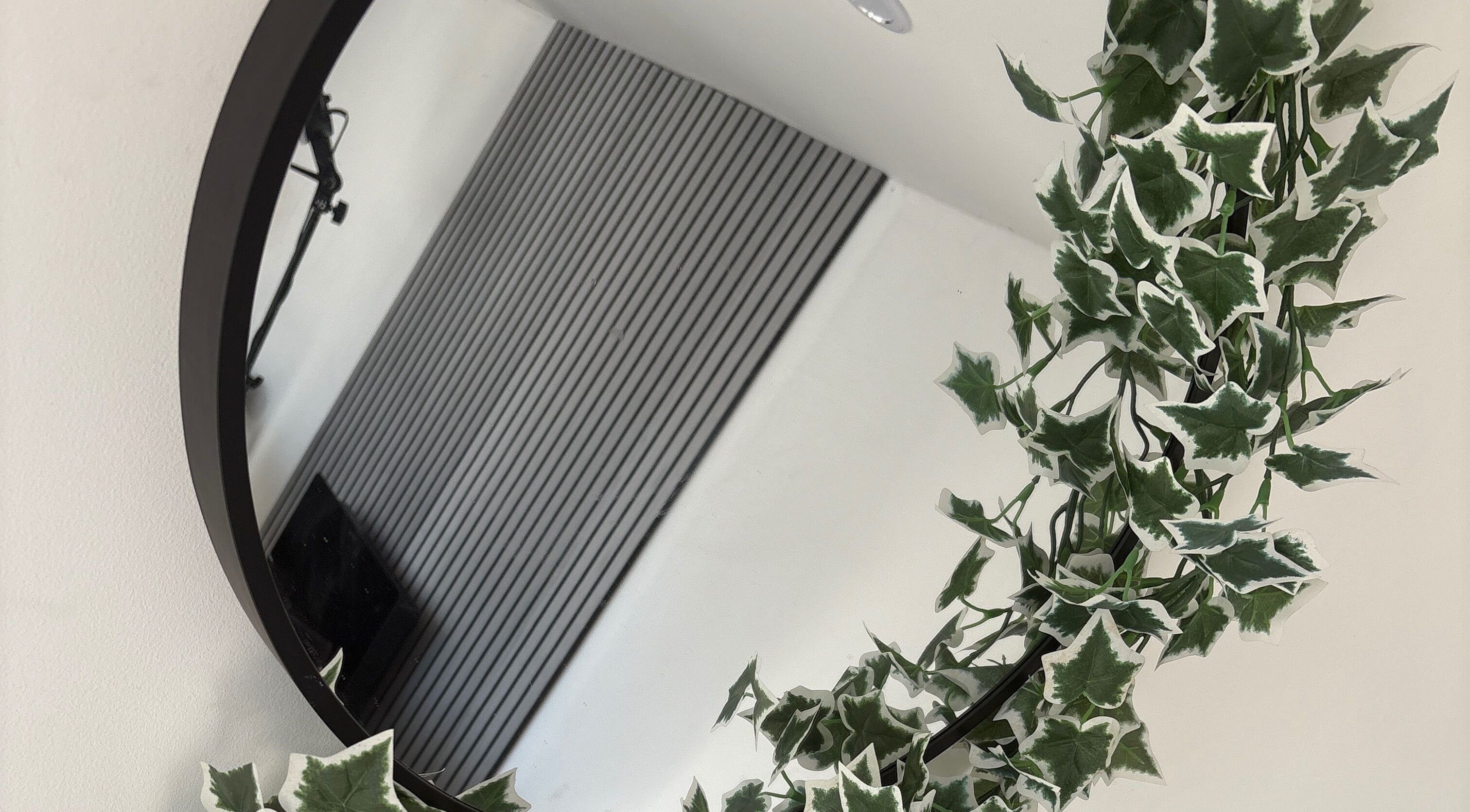 Elegant round mirror with lush ivy at Forever Graceful Beauty & Aesthetics, Sunderland, England, GB.