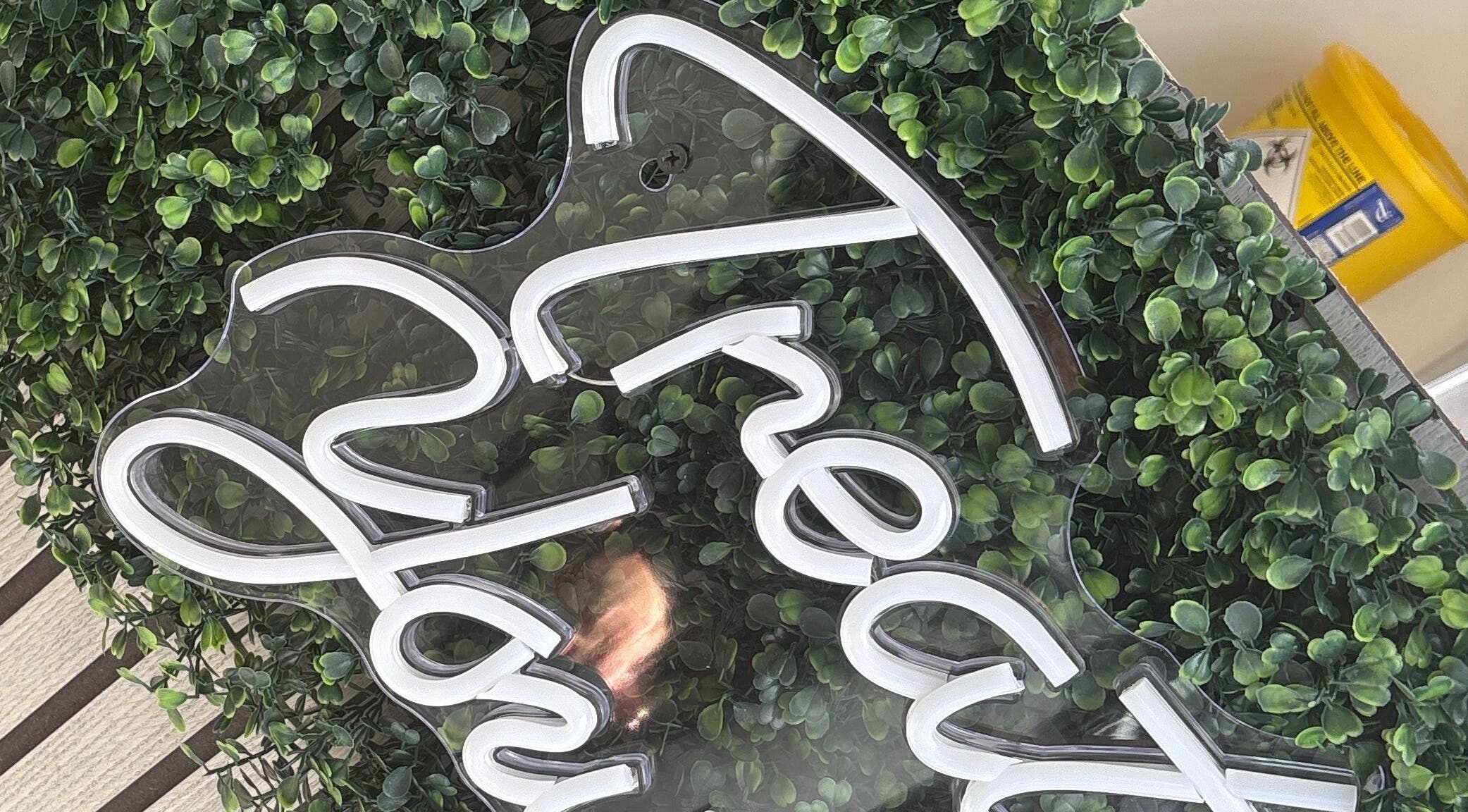 Neon sign with lush green backdrop at Forever Graceful Beauty & Aesthetics, Sunderland, England, GB.