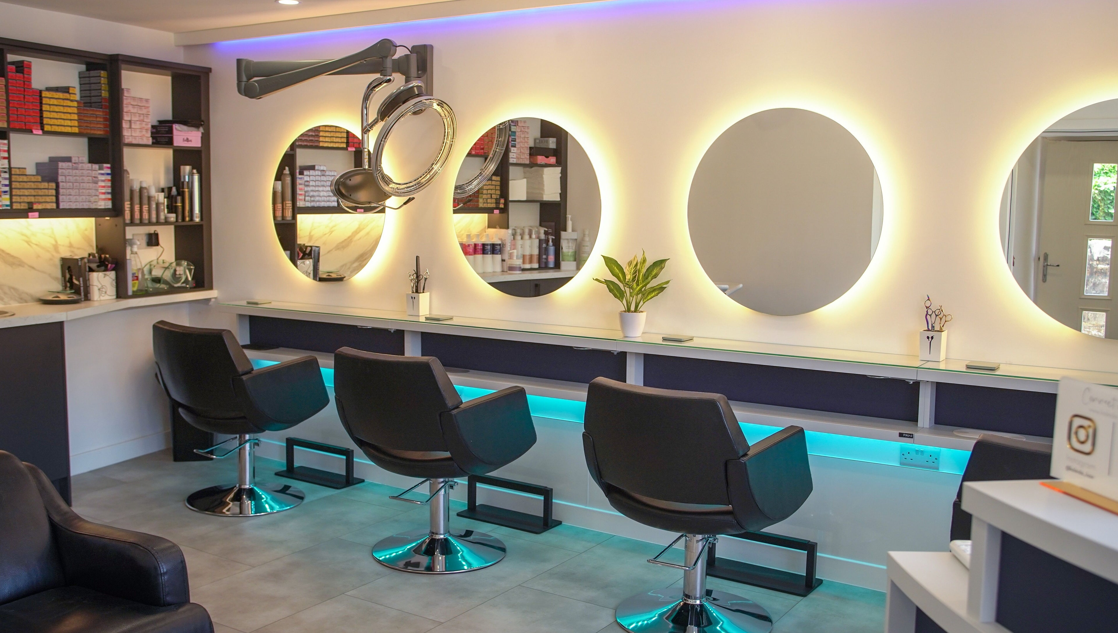 Modern salon chairs and illuminated mirrors at Kaleido Hair & Beauty, Whitwell, England, GB.