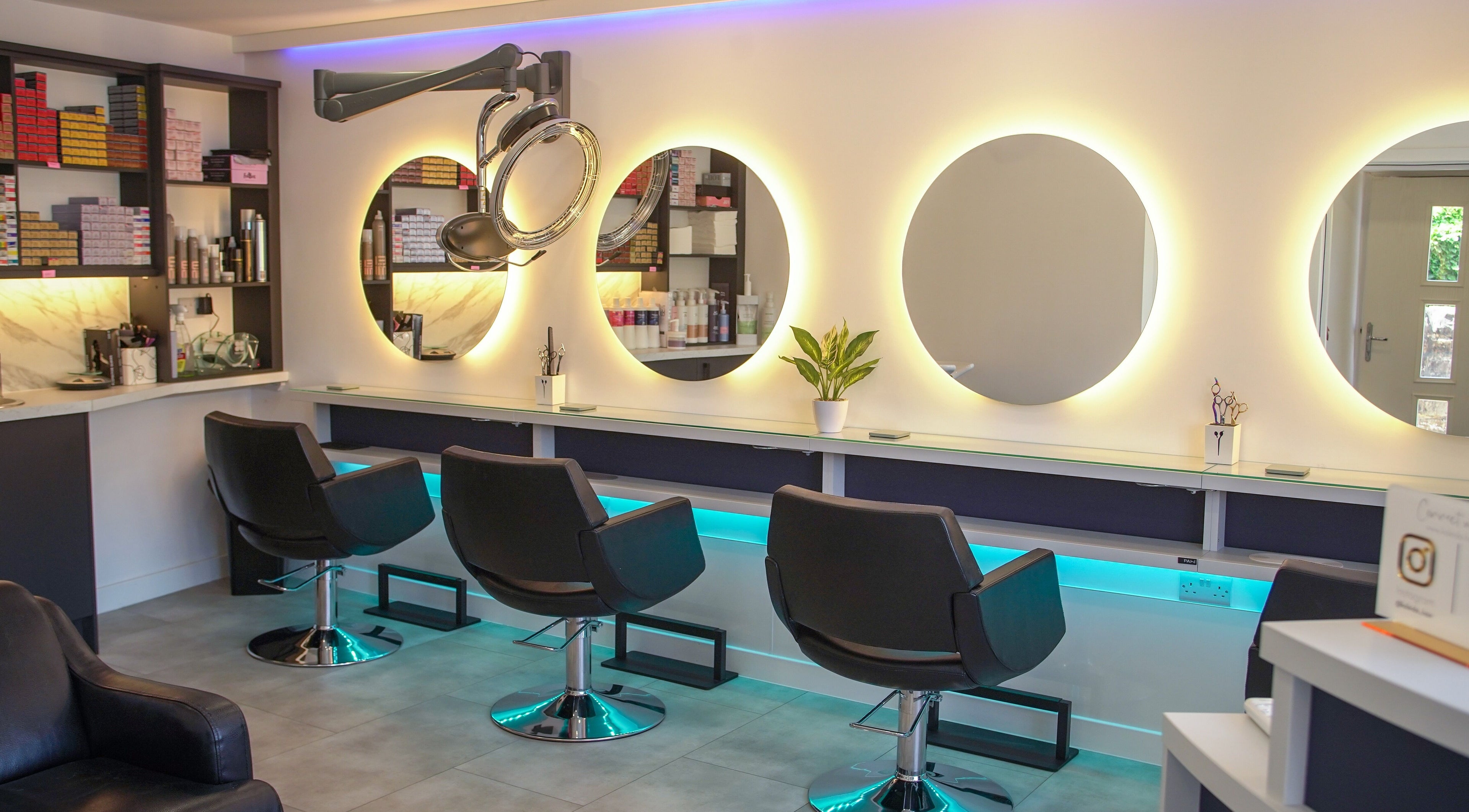Modern salon chairs and illuminated mirrors at Kaleido Hair & Beauty, Whitwell, England, GB.