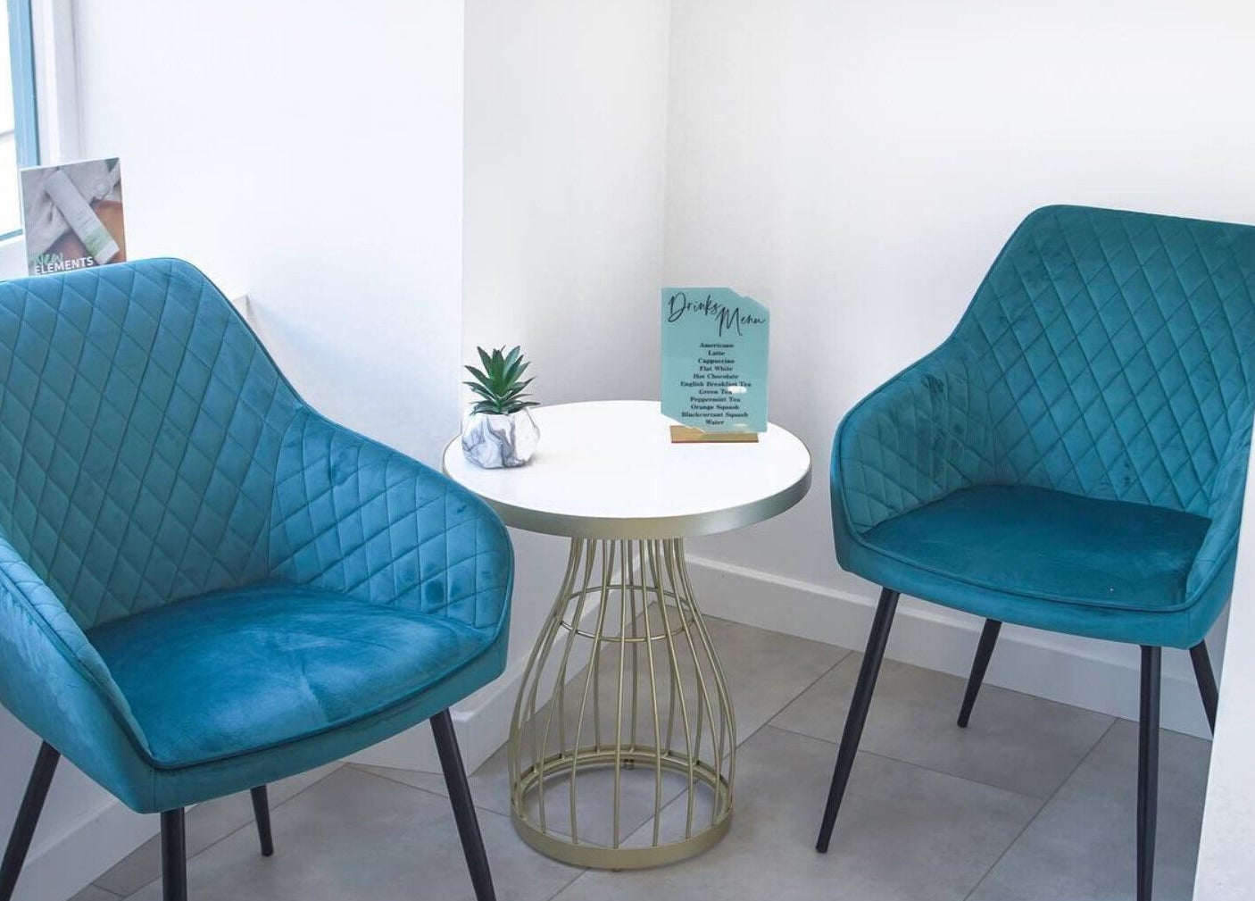 Stylish blue chairs and round table at Kaleido Hair & Beauty, Whitwell, England, GB, perfect relaxation spot.