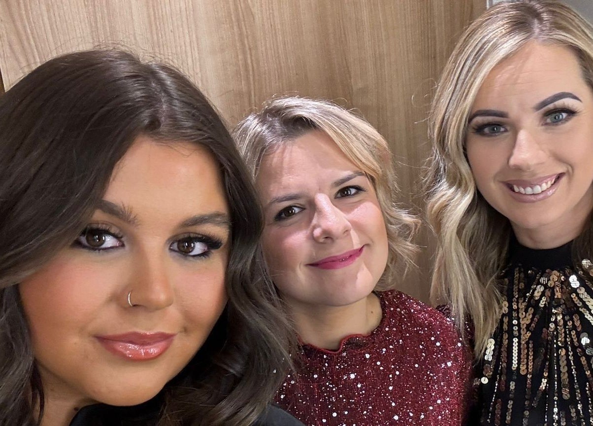 Three women smiling at Kaleido Hair & Beauty, Whitwell, England, GB, showcasing elegant hairstyles and makeup.