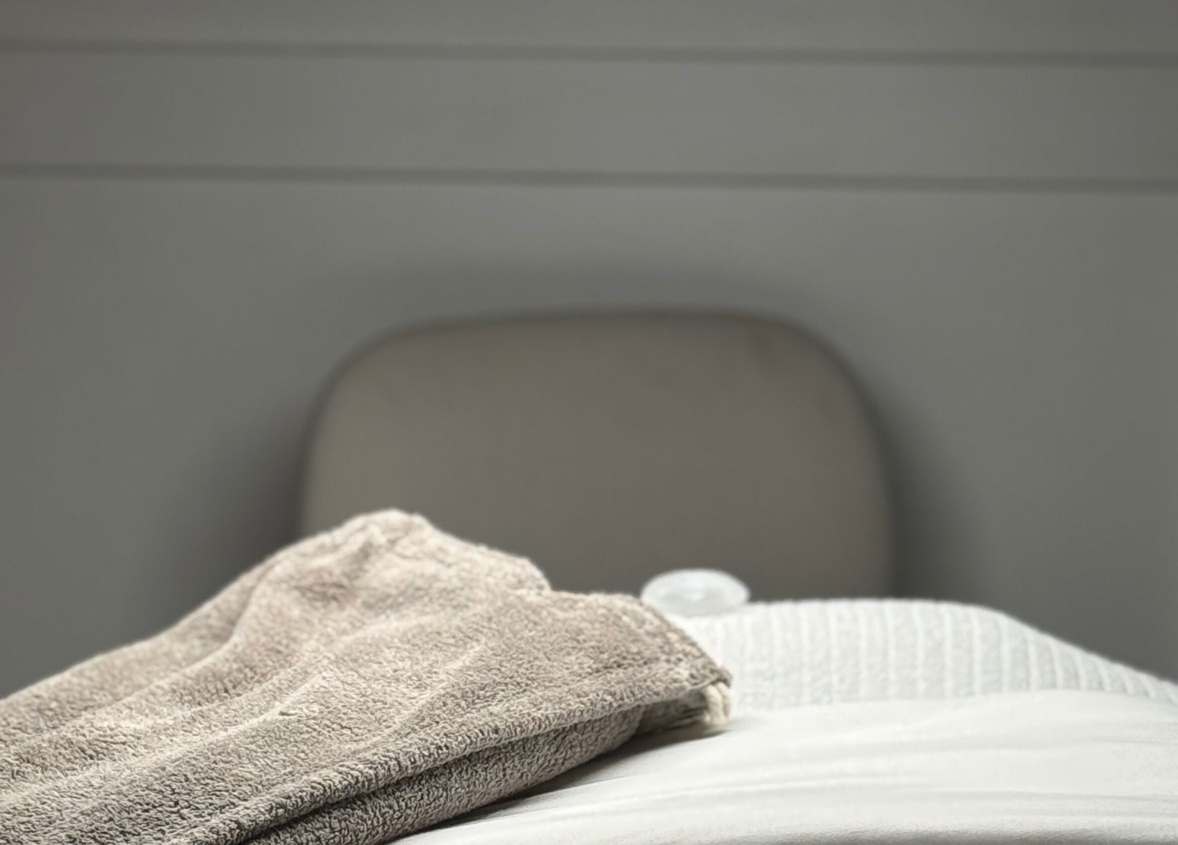 A plush towel on a spa chair at Allyson O’Brien | Nutrition & Advanced Aesthetics, Surrey, British Columbia, CA.