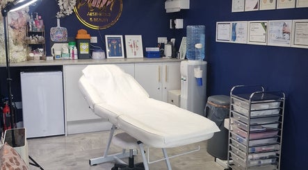 Treatment room at Pout Aesthetics and Beauty, Blackpool, England, GB with bed, certificates, and decor.