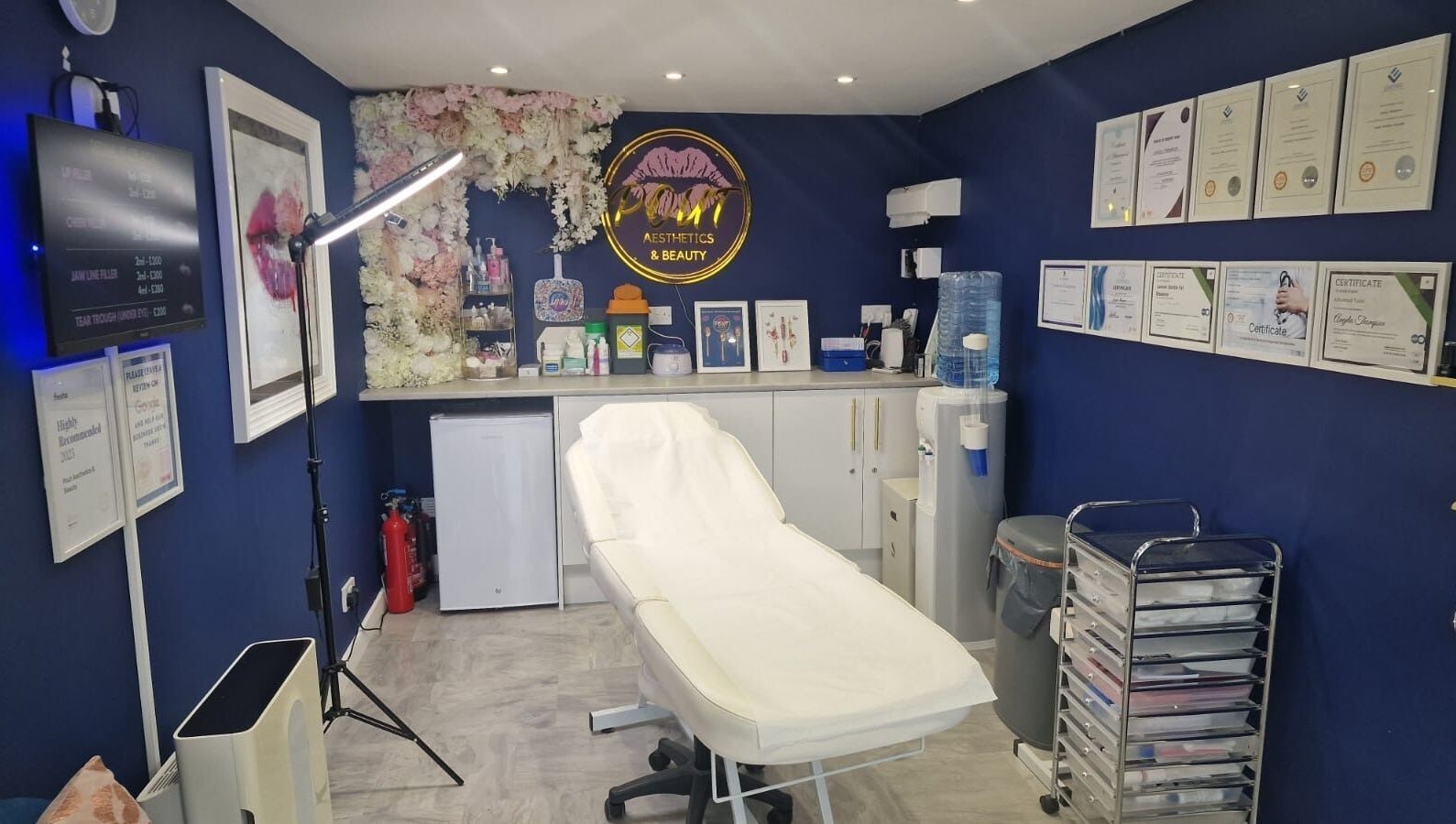 Sophisticated treatment room at Pout Aesthetics and Beauty in Blackpool, England, GB with certificates on display.