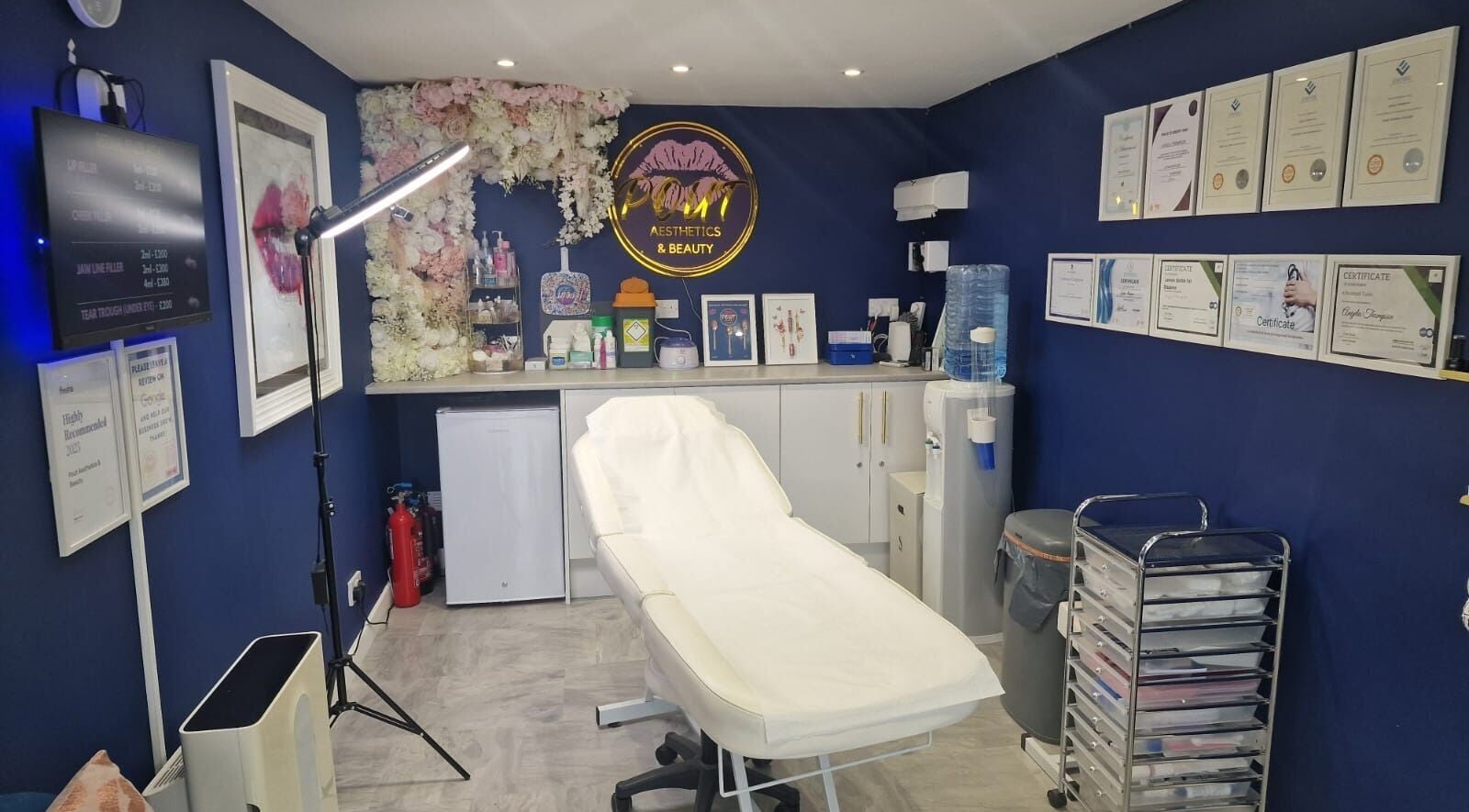 Sophisticated treatment room at Pout Aesthetics and Beauty in Blackpool, England, GB with certificates on display.