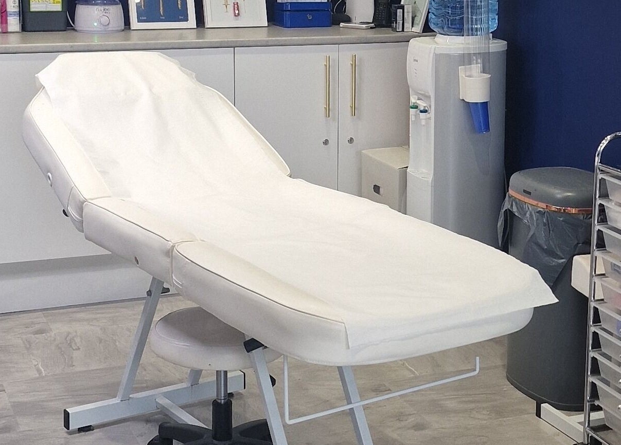 Treatment room at Pout Aesthetics and Beauty in Blackpool, England, GB, with a comfortable, white spa bed.