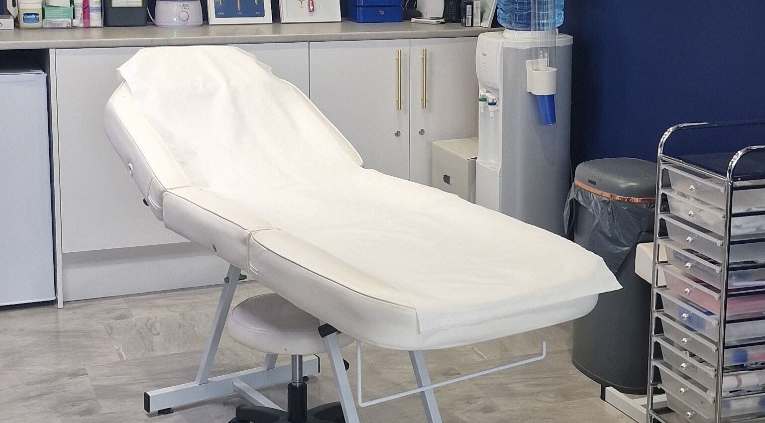 Treatment room at Pout Aesthetics and Beauty in Blackpool, England, GB, with a comfortable, white spa bed.