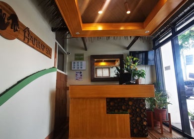 Cozy reception at Hapihap Spa-Sorsogon City, Bicol, PH with wooden decor and lush plants.