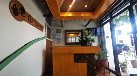 Cozy reception at Hapihap Spa-Sorsogon City, Bicol, PH with wooden decor and lush plants.