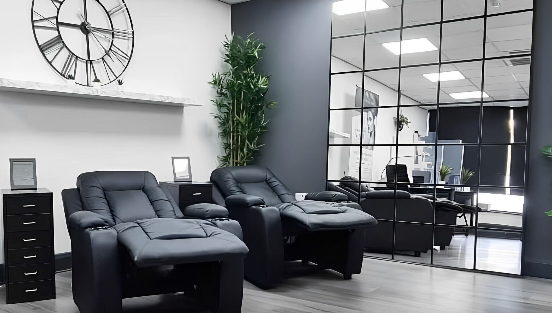 Modern lounge chairs at Pure Nails and Aesthetics, Newton Abbot, England, GB offer a relaxing spa ambiance.