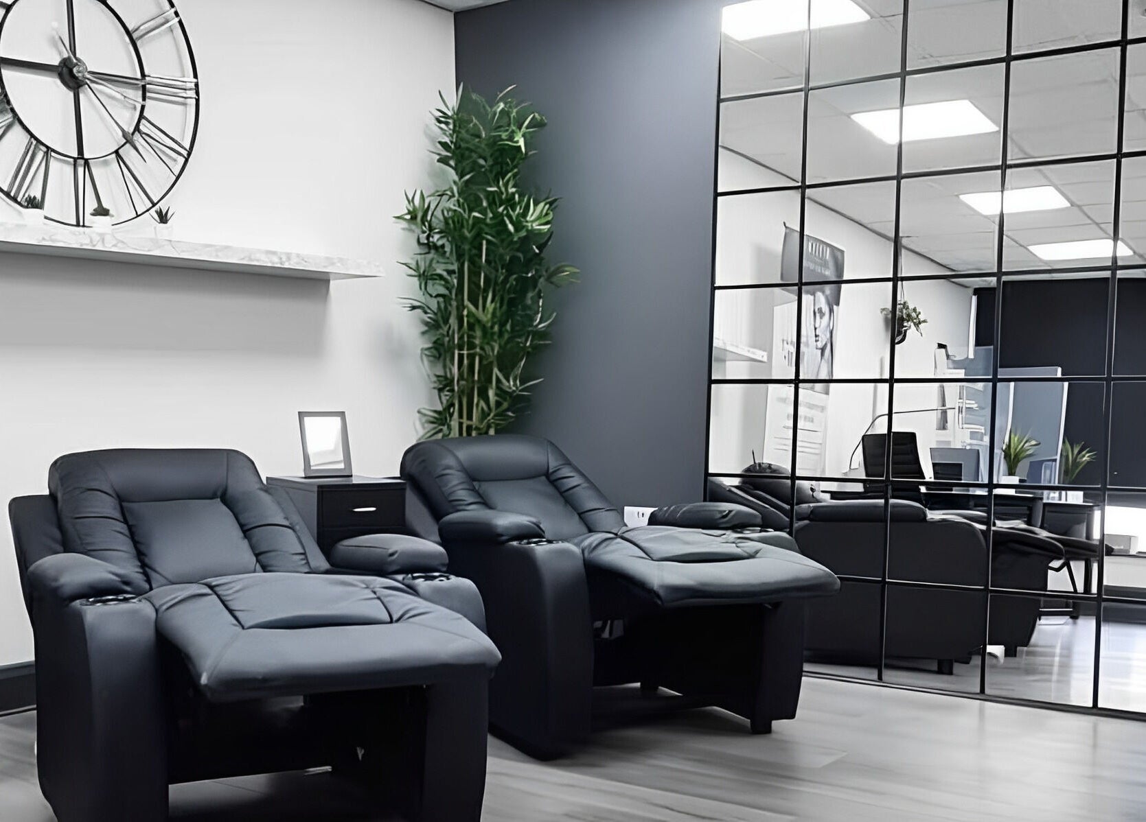 Modern lounge chairs at Pure Nails and Aesthetics, Newton Abbot, England, GB offer a relaxing spa ambiance.