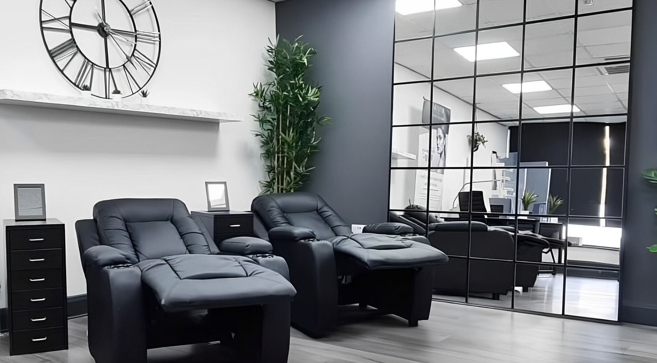 Modern lounge chairs at Pure Nails and Aesthetics, Newton Abbot, England, GB offer a relaxing spa ambiance.