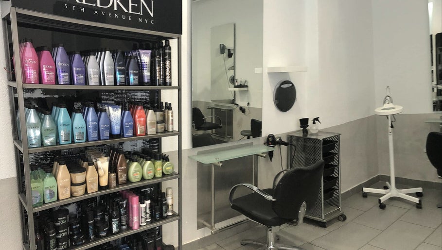 Salon interior at Eden in Palma, Illes Balears, ES featuring sleek chairs and premium hair products.