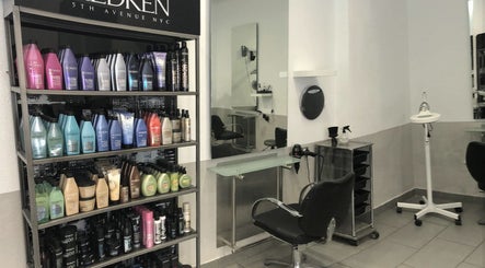 Salon interior at Eden in Palma, Illes Balears, ES featuring sleek chairs and premium hair products.