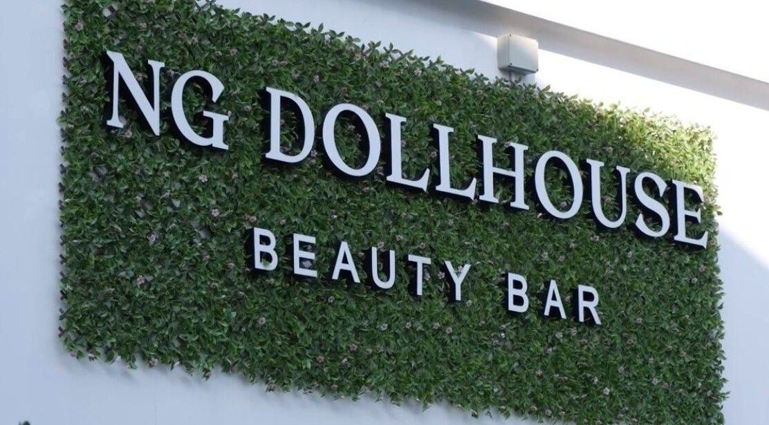 NG Dollhouse sign on a lush green wall in Germasogeia, Limassol, CY.