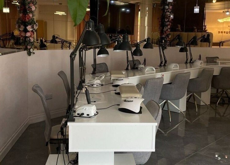 Sleek nail station setup at NG Dollhouse, Germasogeia, Limassol, CY featuring modern chairs and lamps.