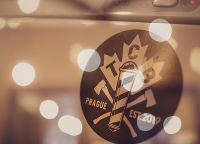 Logo of The Canadian Barbershop, Praha, Hlavní město Praha, CZ, illuminated with bokeh lights.