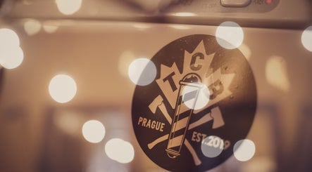 Logo of The Canadian Barbershop, Praha, Hlavní město Praha, CZ, illuminated with bokeh lights.