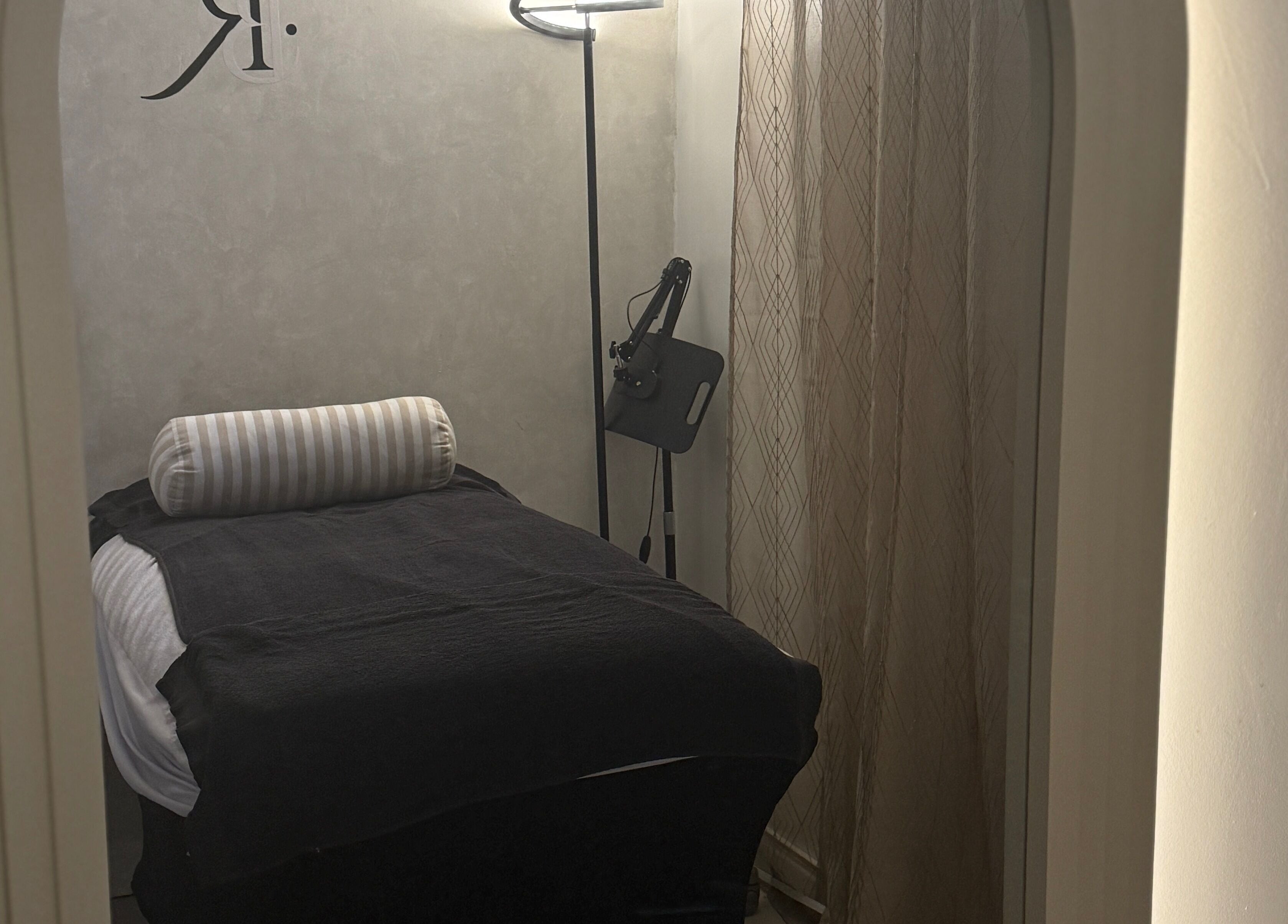 Tranquil treatment room at Body Revolution Aesthetics in Leeds, England, GB featuring a cozy bed and soft lighting.