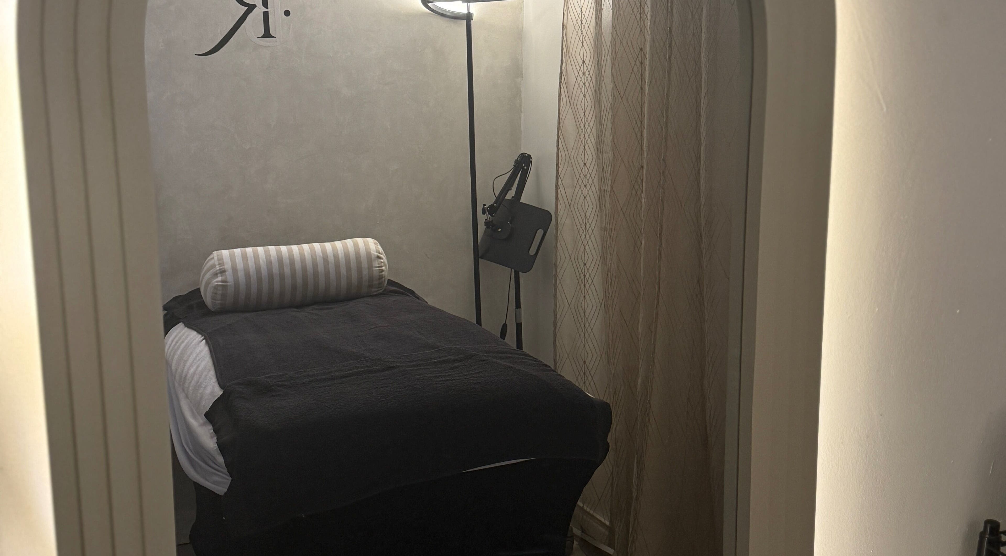 Tranquil treatment room at Body Revolution Aesthetics in Leeds, England, GB featuring a cozy bed and soft lighting.