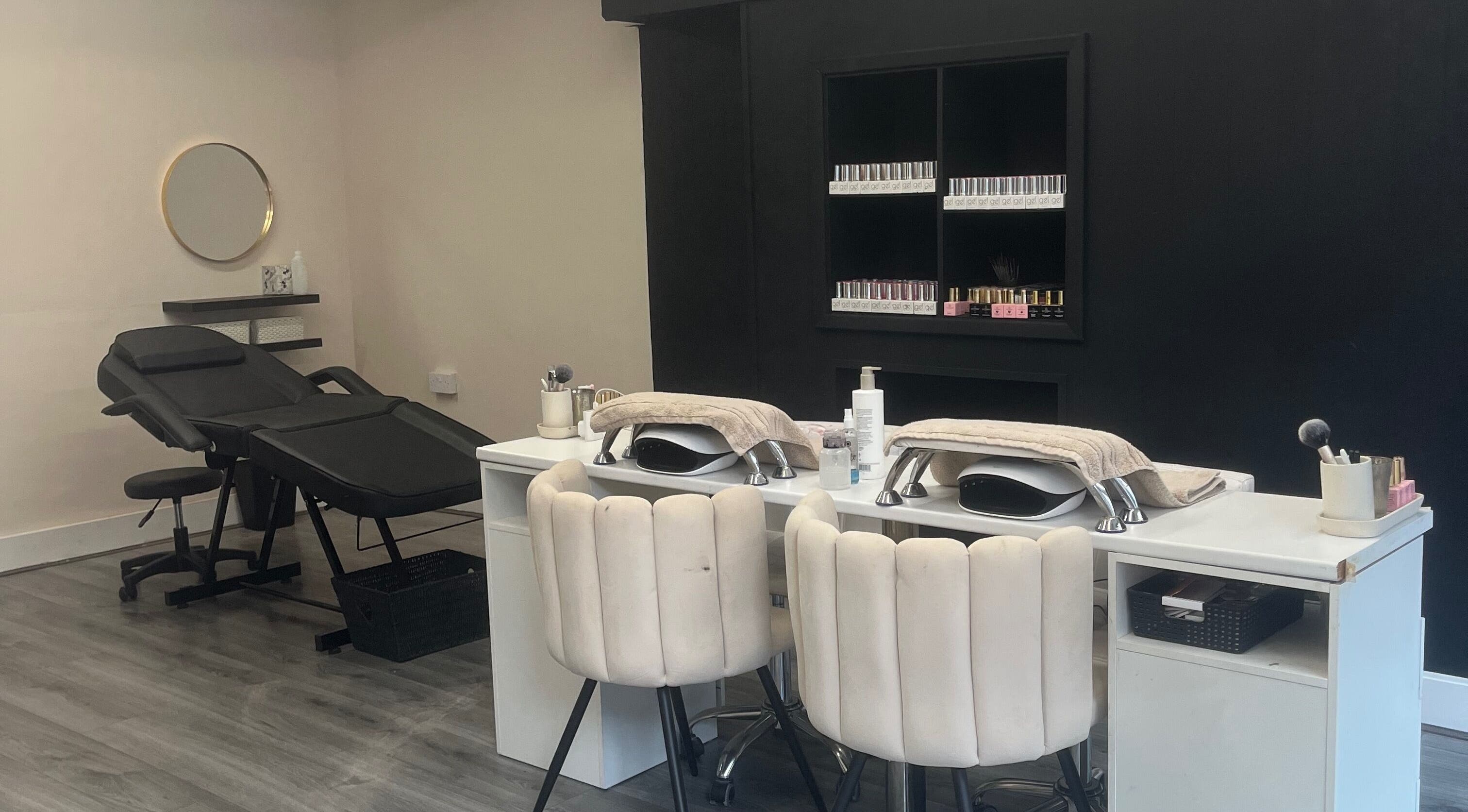 Chic salon interior of B Beauty in Ilkeston, England, GB with modern black and white decor and nail care station.