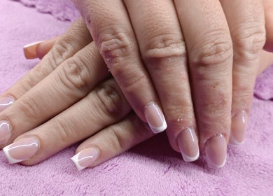 French manicure at Skin and Bling Brackenfell, Cape Town, Western Cape, ZA. Perfectly groomed hands on a purple towel.