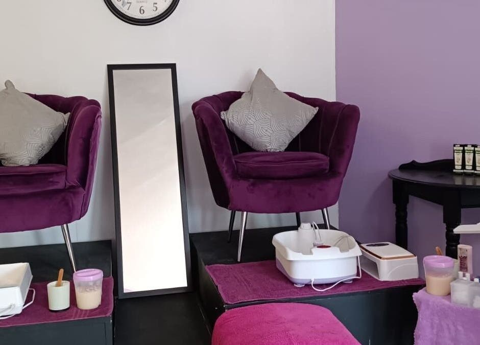 Cozy beauty corner at Skin and Bling Brackenfell in Cape Town, Western Cape, ZA with purple chairs and pedicure setup.