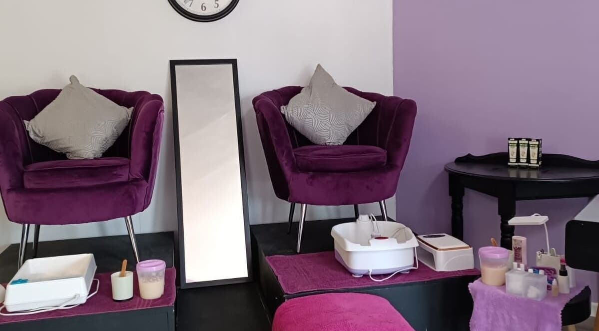 Cozy beauty corner at Skin and Bling Brackenfell in Cape Town, Western Cape, ZA with purple chairs and pedicure setup.