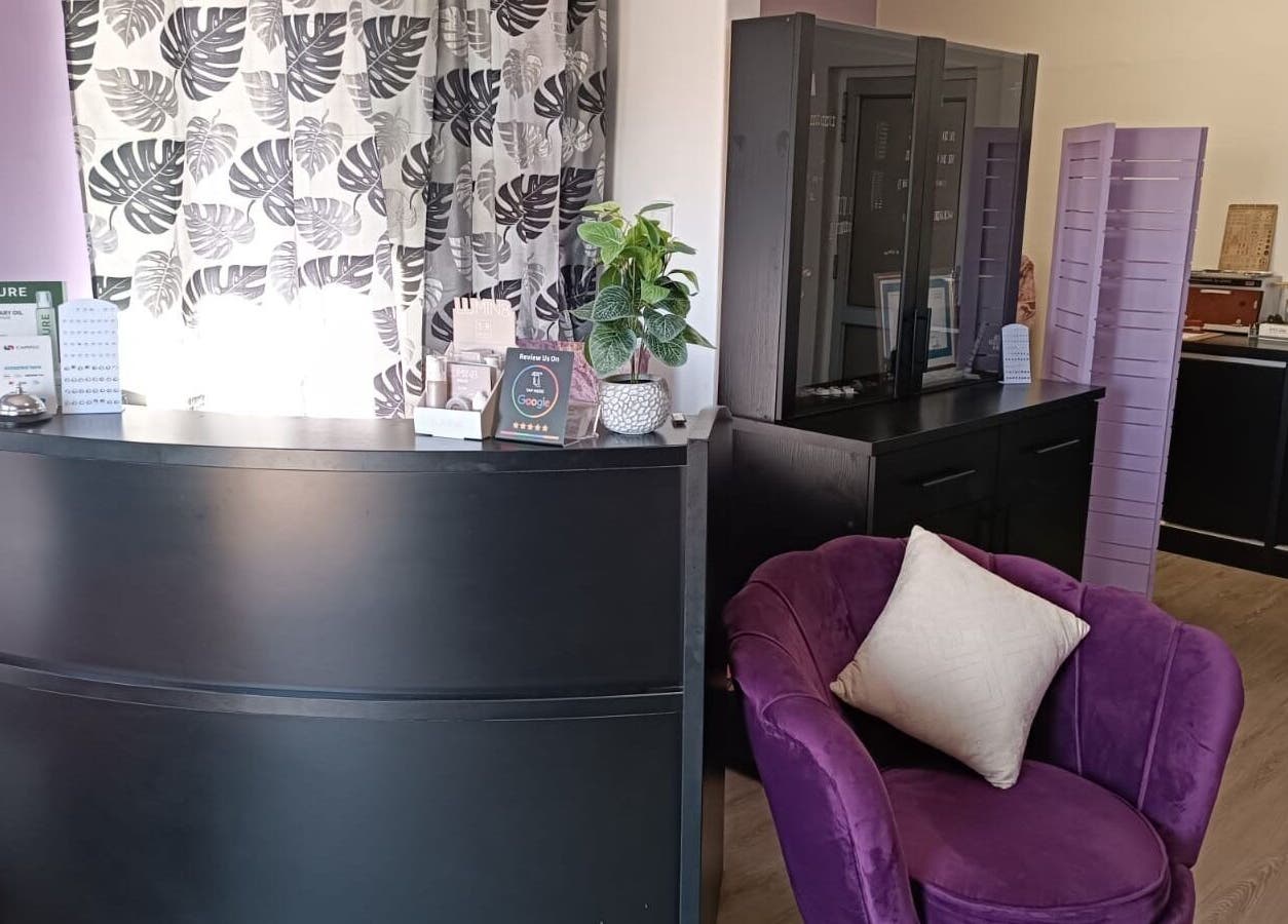 Elegant reception at Skin and Bling Brackenfell, Cape Town, Western Cape, ZA with purple decor and modern furniture.