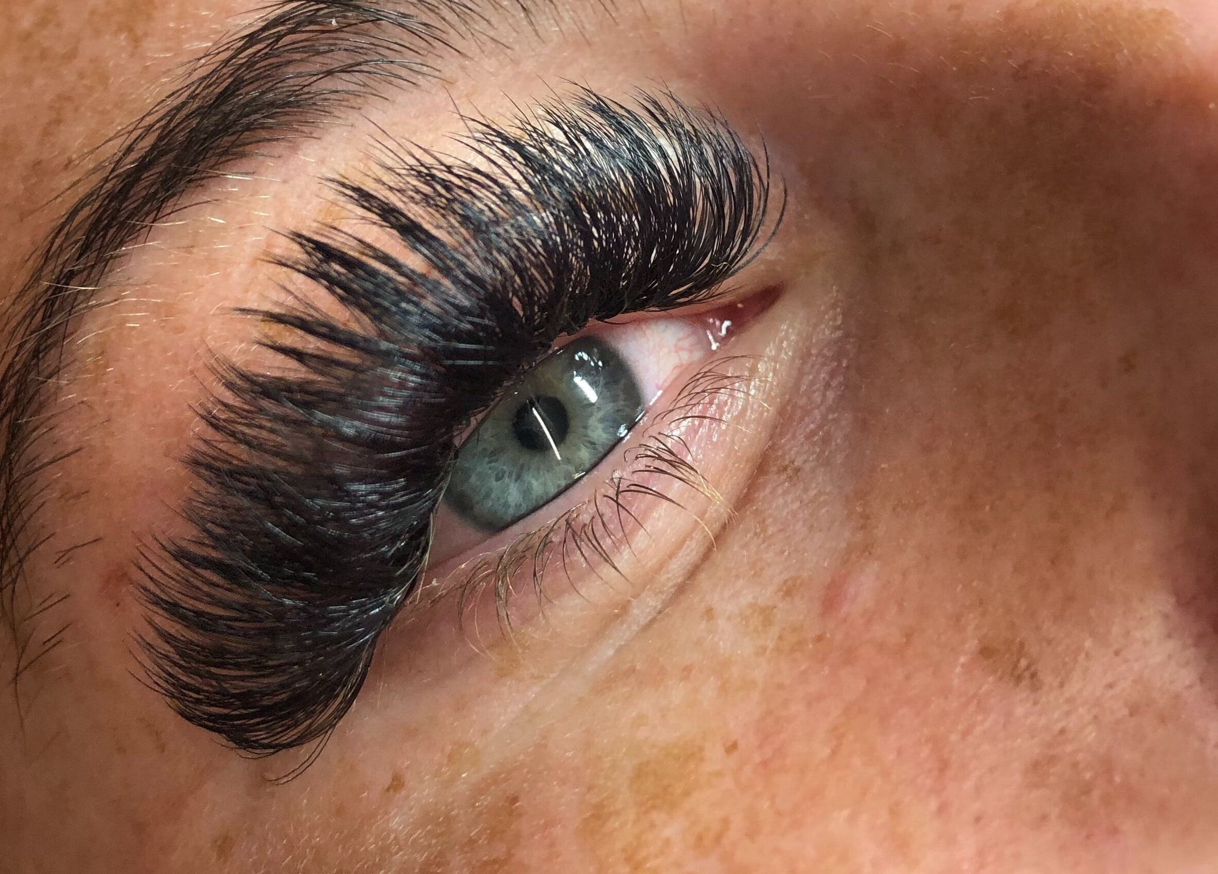 Close-up of eye with lush lashes at Lowes Lashes Aesthetics Sunbed in Faversham, England, GB.