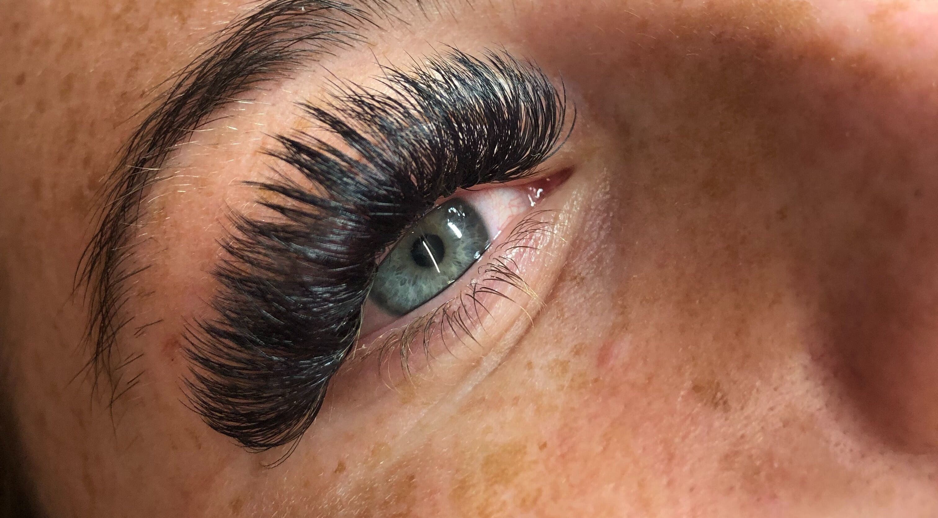 Close-up of eye with lush lashes at Lowes Lashes Aesthetics Sunbed in Faversham, England, GB.