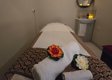 Relaxing massage room at Orchid Beauty & Massage - Kensington, London, England, GB with flowers and soft lighting.