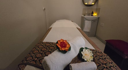 Relaxing massage room at Orchid Beauty & Massage - Kensington, London, England, GB with flowers and soft lighting.