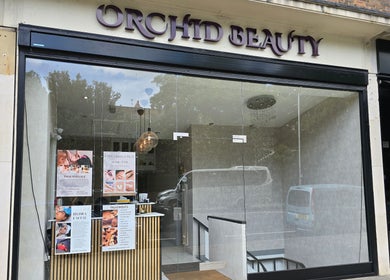 Front view of Orchid Beauty & Massage - Kensington, London, England, GB, showcasing a chic glass entrance.