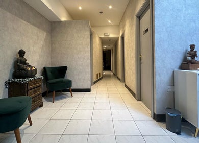 Serene hallway at Orchid Beauty & Massage - Kensington, with candles and statues, London, England, GB.