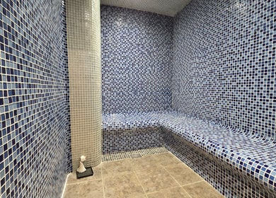Relaxing mosaic-tiled steam room at Orchid Beauty & Massage - Kensington, London, England, GB.