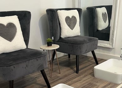 Elegant seating with heart pillows at Tantalize, Telford, England, GB beauty lounge.