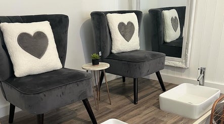 Elegant seating with heart pillows at Tantalize, Telford, England, GB beauty lounge.