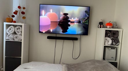 Relaxing spa room at K Beauty Bliss, Swindon, England, GB with cozy towels and candles on display.