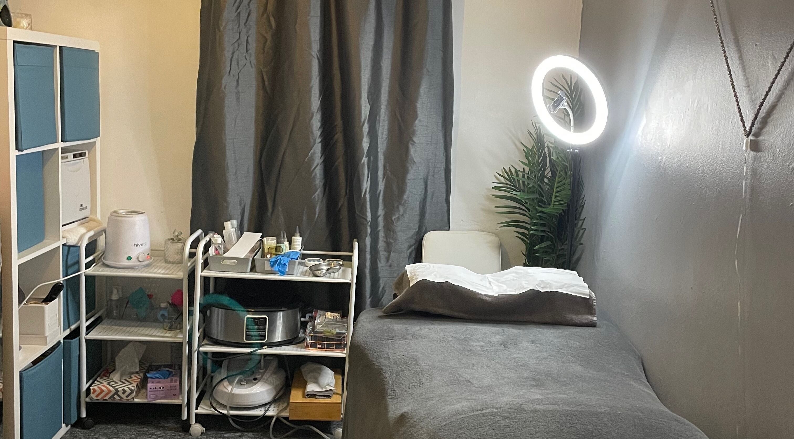K Beauty Bliss treatment room in Swindon, England featuring spa bed and beauty equipment.