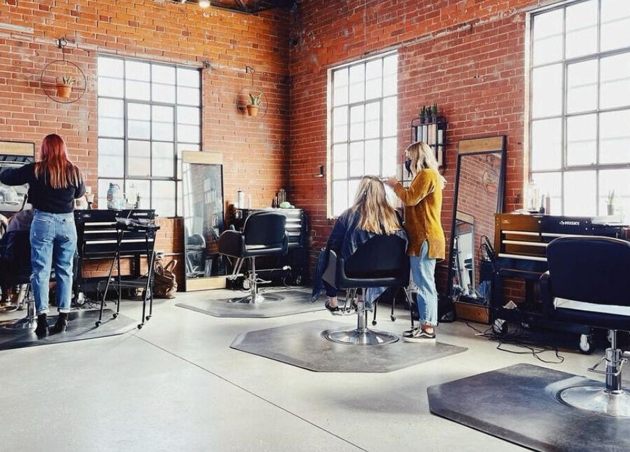 Deeprock Salon interior with stylists at work, located in Oklahoma City, Oklahoma, US.