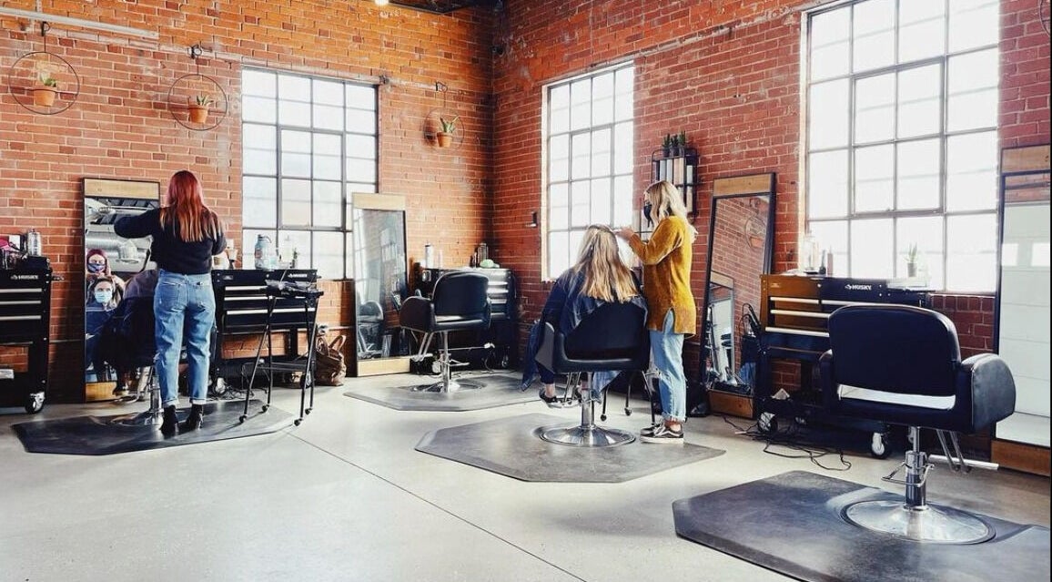 Deeprock Salon interior with stylists at work, located in Oklahoma City, Oklahoma, US.