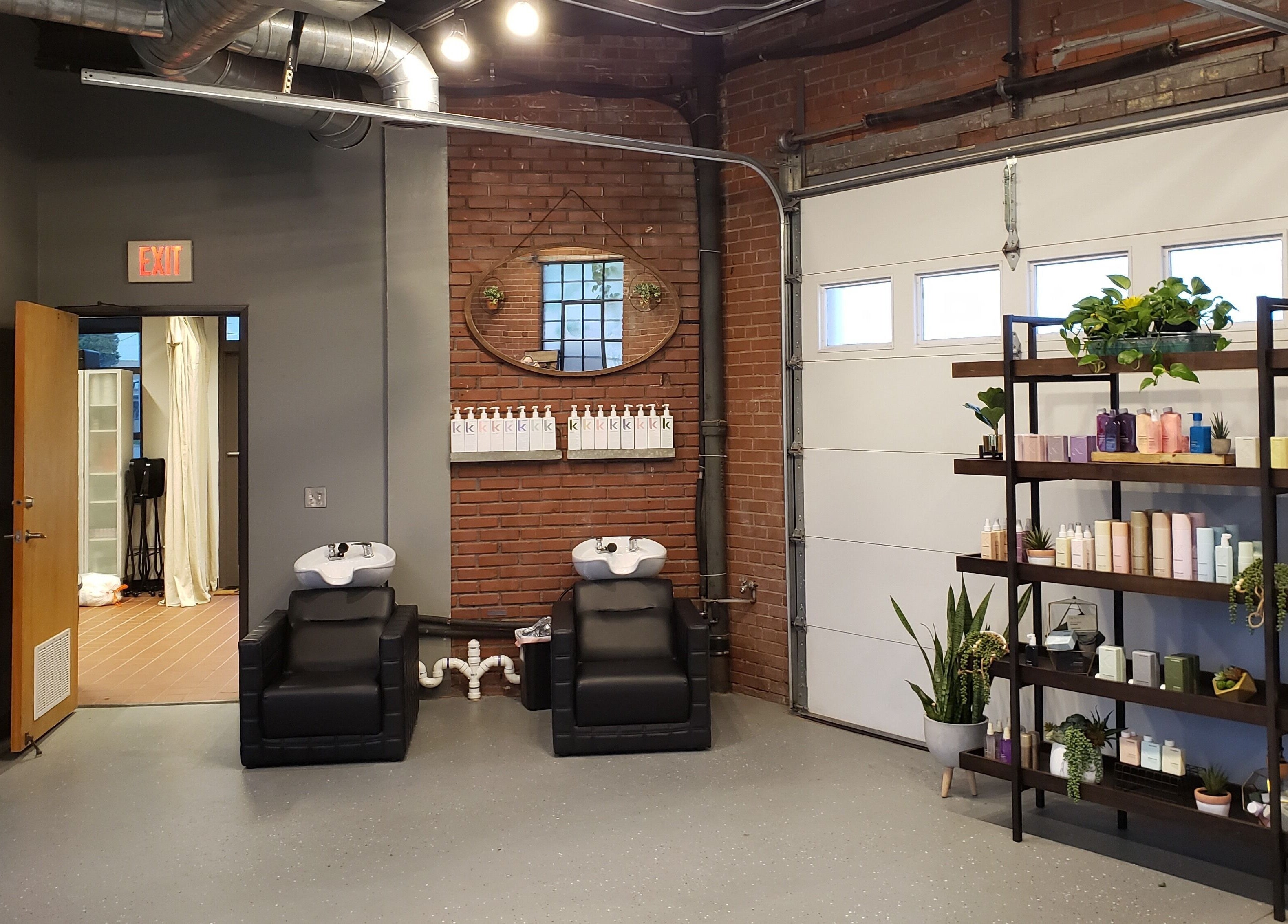 Modern salon interior at Deeprock Salon, Oklahoma City, Oklahoma, US with stylish products and wash stations.