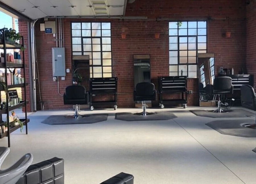 Modern salon chairs at Deeprock Salon in Oklahoma City, Oklahoma, US with industrial-style decor and large windows.
