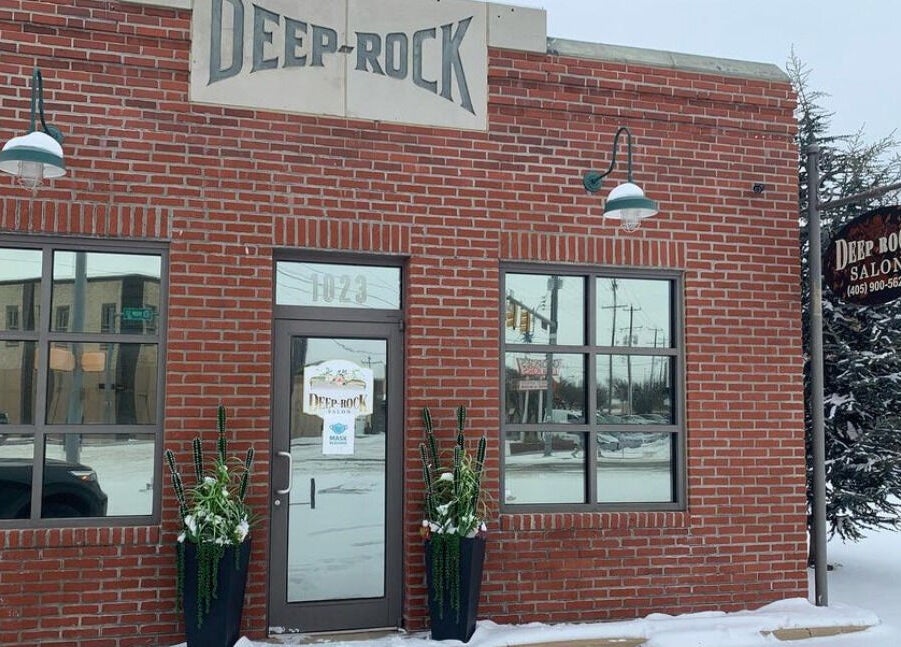 Cozy brick exterior of Deeprock Salon in snowy Oklahoma City, Oklahoma, US.