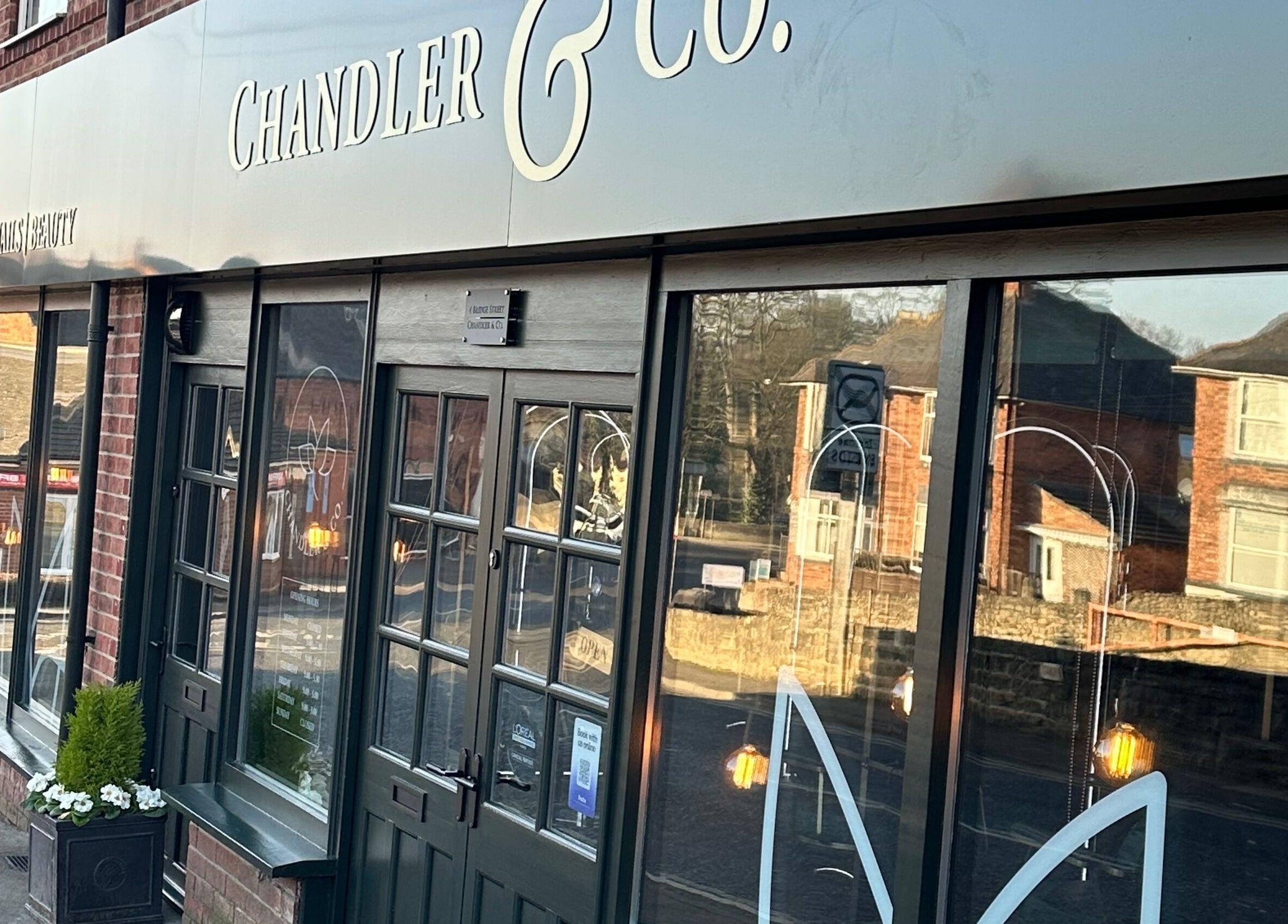 Front view of Chandler and Co. salon in Bedale, England, GB with elegant signage and large windows.
