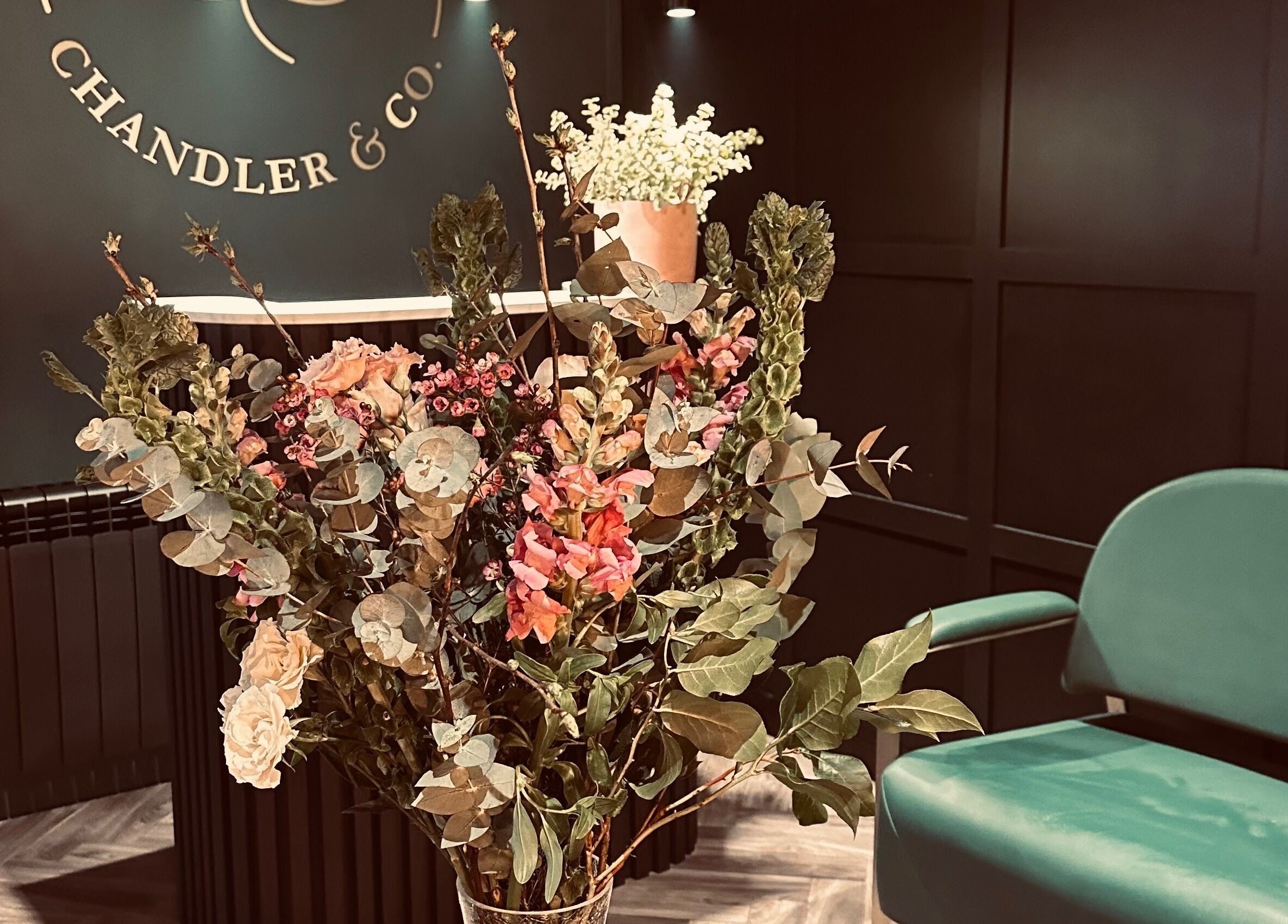 Chandler and Co. venue in Bedale, England featuring elegant flowers and a green seat in a stylish setting.