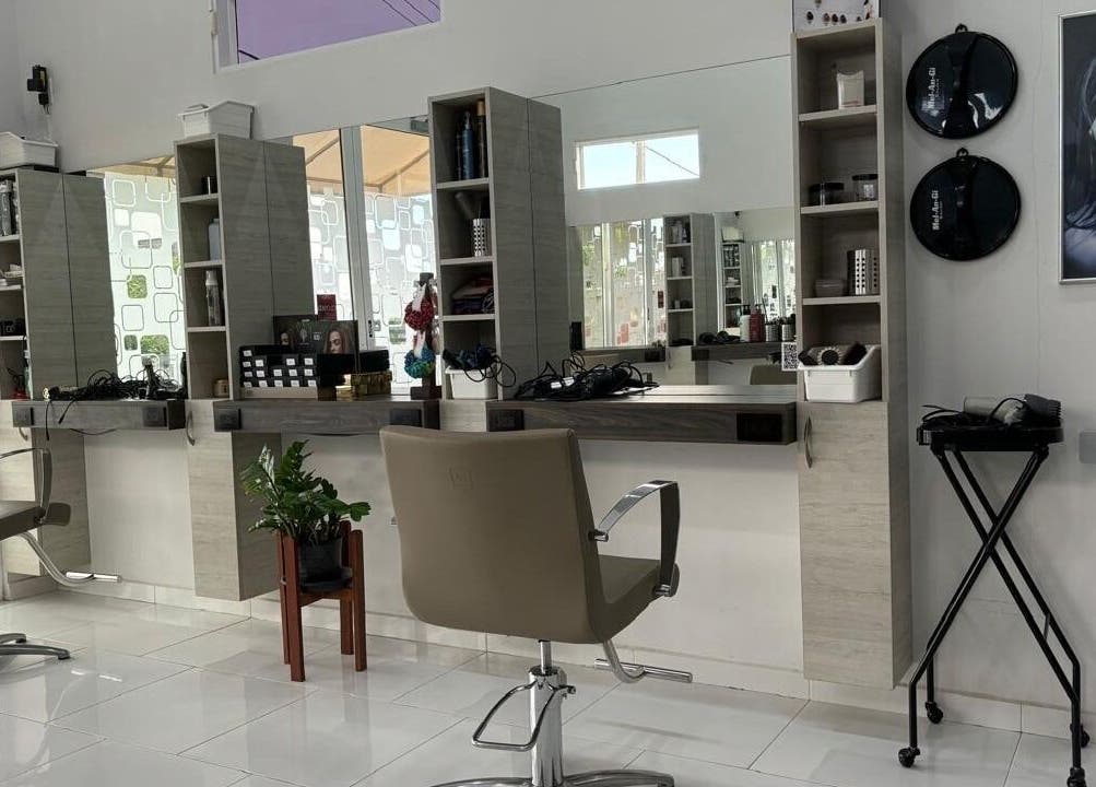Modern salon interior at Mel An Gi Hair NV, Paramaribo, Paramaribo, SR with stylish chairs and sleek mirrors.