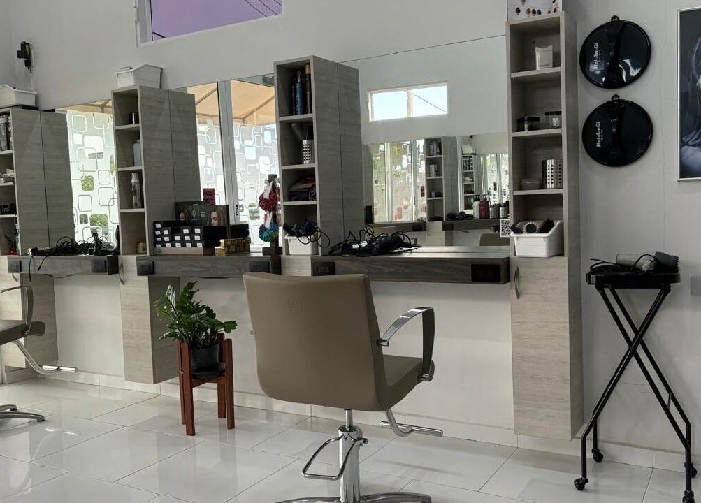 Modern salon interior at Mel An Gi Hair NV, Paramaribo, Paramaribo, SR with stylish chairs and sleek mirrors.